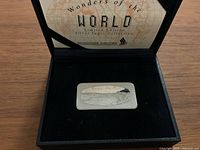 Front of the silver ingot showing engraving of Niagara Falls and 'Wonders of the World' series text.