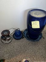 All three fountains shown together against a white wall on carpet.