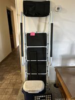 Full view of large and small step stools and cooler arranged upright against a wall, showing their size and color.