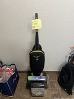 Front view of Soniclean Soft Carpet vacuum with fragrance pod box and vacuum bags box in front of it.