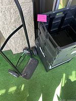 Side view of Milwaukee hand truck dolly showing metal frame, handle, and wheels