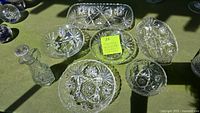 Seven vintage clear glass serving pieces with intricate Star of David pressed patterns, showing set contents and detail