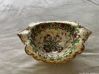 Top view of the ornate antique Nippon porcelain bowl showing colorful floral and gold hand-painted designs inside and on rim.