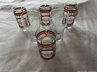Top view showing six collectible branded glasses with holiday color designs