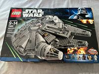 Top front of LEGO Star Wars Millennium Falcon #7965 box showing ship image, piece count (1254 pcs), age range, and branding.