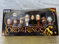 Front image of the unopened Pez Lord of the Rings collectible set showing 8 character dispenser heads in a window box.