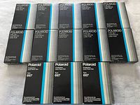 Front view showing 13 unopened Polaroid Type 667 film packs arranged in three rows.