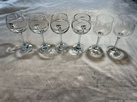 Photo showing all six wine glasses in the set: 2 clear crystal stemware and 4 Olympic wine glasses with textured vertical ribs.