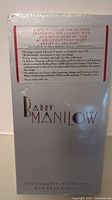Photo of the back cover showing detailed description of the music content and features included in the Barry Manilow Complete Collection boxed set.