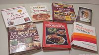 Photo of all six cookbooks arranged together showing covers and titles clearly