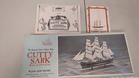 Box and printed materials for Cutty Sark wood model kit, including instruction booklet and product insert.