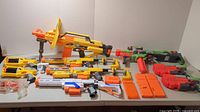 Full view of nerf blasters laid out on table showing all items and accessories