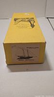 Side view of the box showing a black silhouette image of the Benjamin Latham ship and text Model Shipways.