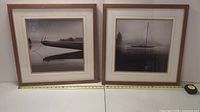 Two framed maritime sailboat prints side by side on a white surface. Each frame is square with wooden borders and double mats.