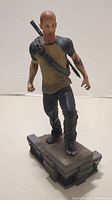 Full view of the Cole McGrath statue standing on the original display base showcasing details of the figure and weapon
