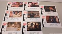 Eight Scarface movie lobby cards laid out in two rows showing different scenes and characters from the film, with white borders and text.