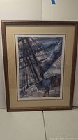 Framed lithograph showing the maritime scene with sailors furling the mainsail, wooden frame and glass cover, standing on floor against a wall.