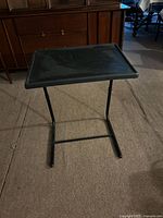 Perspective view of black folding tray table fully assembled