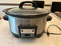 Front view of slow cooker showing digital control panel and glass lid