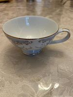 Side view of teacup showing floral pattern and handle