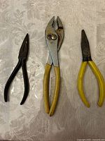 All three pliers grouped on surface