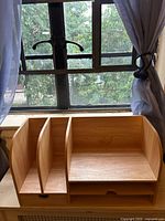 Front view showing three vertical slots, open compartment and drawer closed