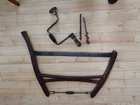 overall view of saw, brace drill and bits on floor