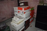 Stacked cardboard boxes containing cookbooks