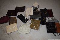 Group shot of approx. 15 assorted vintage handbags and clutches on floor