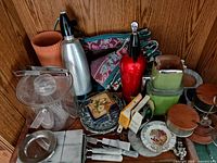 Overview showing soda siphons, ice bucket, placemats, dish, knives, tools