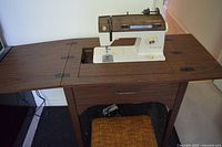 Singer 930 installed in sewing cabinet with chair