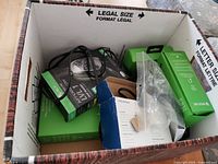 Box with assorted Xbox accessories and alarm clock packaging