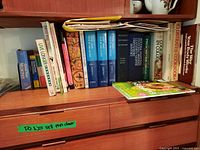 Bookshelves with various cookbooks, English dictionary volumes including Webster's New World Dictionary and Live Longer book.