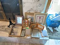 Various frames and items grouped on marble surface showing shapes, colors, and arrangements