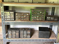 Shelf with seven hardware storage boxes containing small drawers filled with nuts, screws, bolts, and fasteners
