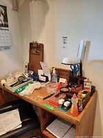 Overview of desk with various office supplies including phone, glue, tape, and rulers.