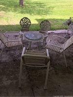 Overall view of the patio set showing the table and six chairs outdoors