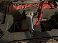 Open case showing pneumatic tile setter gun and coiled red air hose inside foam cutouts