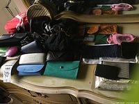 Full overview of vintage purses, make-up bags, wallets, change purses laid on a table