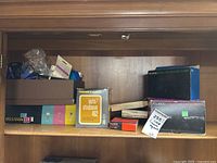 Shelf with multiple vintage camera accessories and equipment in original and storage boxes.