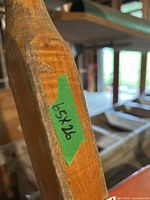 Close-up of a wooden handle with green tape label reading '65x26' indicating dimensions.