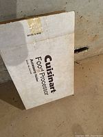 Box of Cuisinart Food Processor Accessory Holder with visible wear.