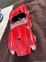 Top view showing detailed glossy red body with Ferrari badge on hood and front lights