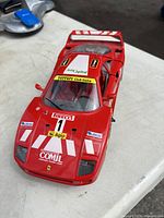 Top-front angled view showing racing decals, sponsor logos, and vehicle details on the Ferrari F40 model.