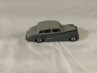 Side view showing the two-tone gray paint and whitewall tires on the diecast model car.