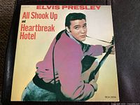Front cover of a 45 RPM Elvis Presley record with 'All Shook Up and Heartbreak Hotel' text and image of Elvis playing guitar.