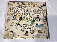 Front cover of the Led Zeppelin III vinyl album showing colorful, psychedelic collage artwork.