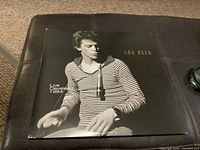 Front cover of the Lou Reed Live Cleveland 1984 album. Black and white photo of Lou Reed in striped shirt with album title and artist name.