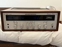 Full front view of receiver showing brushed aluminum panel, knobs and meters