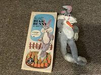 Vintage Mattel Talking Bugs Bunny plush toy alongside its original box on carpeted floor.